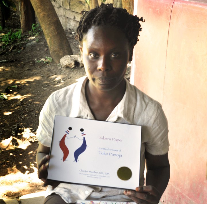 Cecily and the TP certificate at Kibera Paper