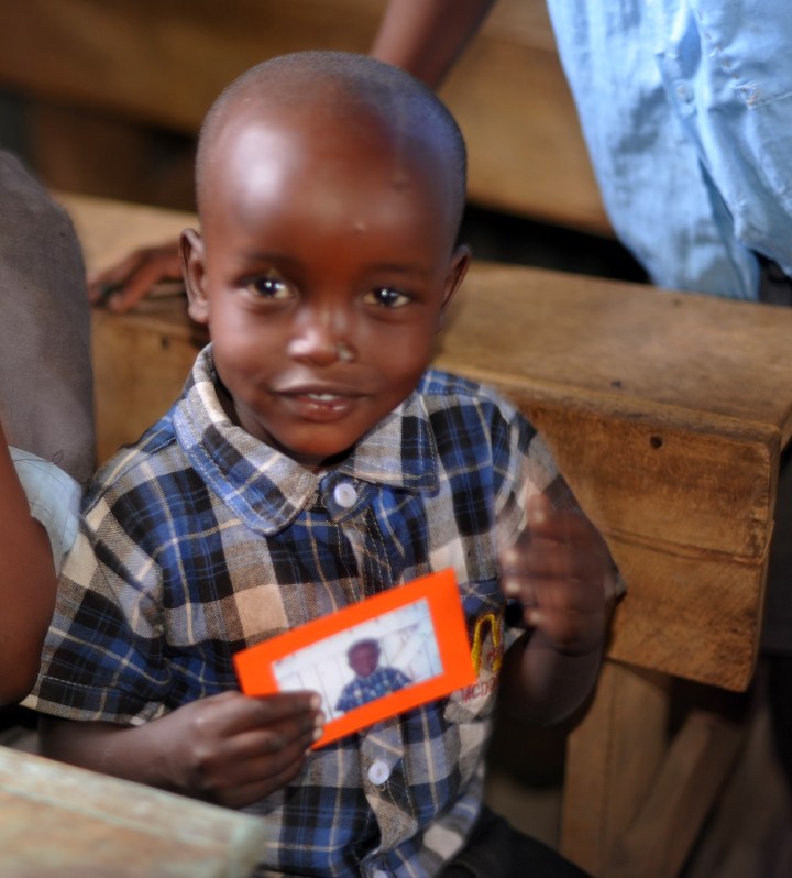 One child showing his photo with its "frame"