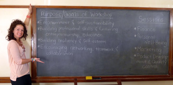 Sarah "posing" with the goals and workshop session titles