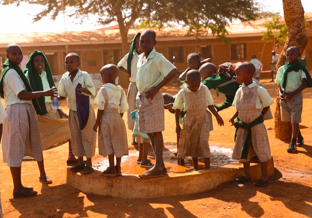 Nyumbani children at the water spout--sometimes you just have to cool off your feet!